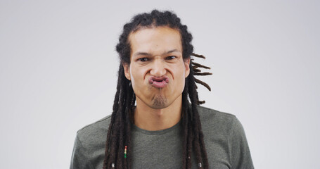 Man, funny face or silly with expression or attitude for joke or comic on a white studio...