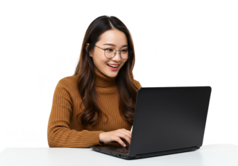 A happy asian woman wearing glasses, smiling and typing on a laptop at a desk, isolated on a transparent background