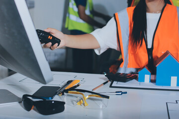 Closeup of team of industrial engineers meeting analyze machinery blueprints consult project on table in manufacturing factory. Working in manufacturing plant or production plant.