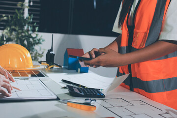 Closeup of team of industrial engineers meeting analyze machinery blueprints consult project on...