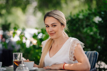 Businesswoman drinking cappuccino relaxing at outdoor cafe
