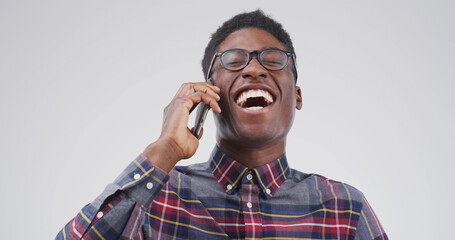 Black man, phone call and happy with laugh in studio for funny story, chat or gossip on white...