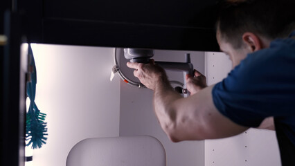Plumber repair mounting new kitchen sink pipes