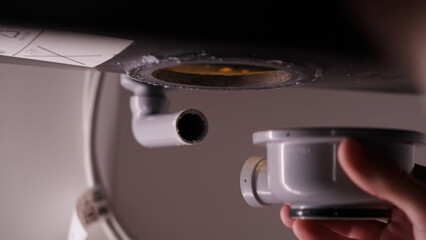 Plumber repair mounting new kitchen sink pipes