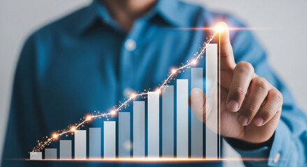 Businessman touching graph of growing business success and achievement