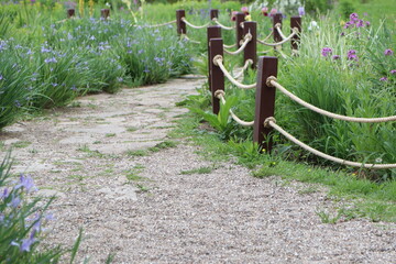 A beautiful scenic garden pathway that is surrounded by luscious greenery all around it