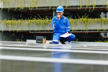 Electrical engineer inspecting and installing a solar panels on the building rooftop.