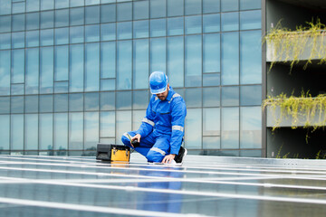 Electrical engineer inspecting and installing a solar panels on the building rooftop.