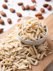 Almond and White Almond Stick set on wooden board and white background.