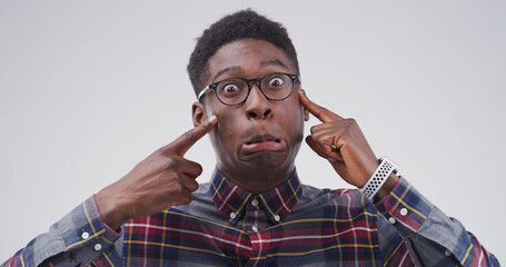 Pointing, silly and portrait of black man in studio with funny face for emoji, comedy and humor....