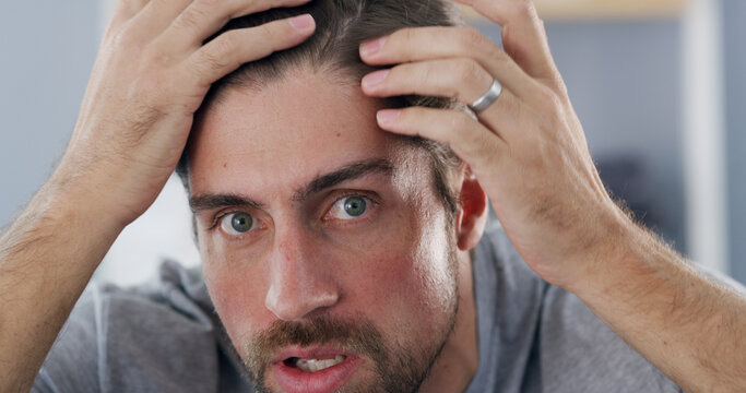 Portrait, man and checking hairline, worry or concerned for hair loss in house, self care and scalp. Home, grooming and inspection for thinning texture, haircare and person with anxiety for baldness