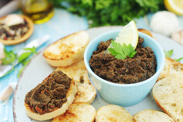 A bowl with tapenade - traditional olive dip in Mediterranean region
