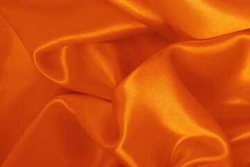 Orange fabric texture background, detail of silk or linen pattern.