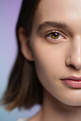 Fototapeta premium Detailed Close-Up of a Young Woman's Face Highlighting Her Flawless Skin Texture and Captivating Eye in a Softly Lit Studio Setting for Beauty and Skincare Advertising