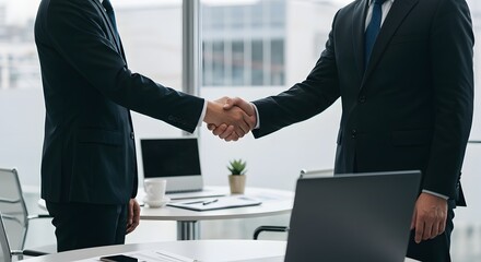 Businessmen Engaged in Handshake After Successful Meeting in Modern Office Environment