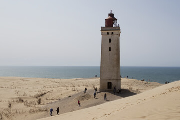 Historic Lighthouse Overlooking the Ocean from a Dune