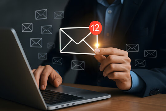 Businessman using laptop with email icon and notification alert communication concept