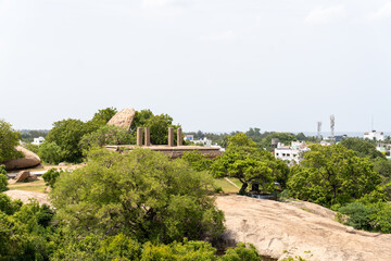 Fototapeta premium A lush green hillside with a city in the distance