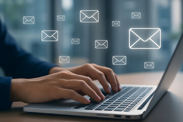 Typing on Laptop with Email Icons Illustrating Communication and Digital Messaging