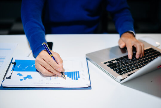 business documents on office table with smart phone and digital tablet and graph financial