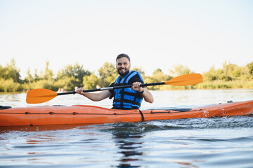 Kayaker paddling on lake enjoying water sports and recreation