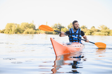 Kayaker paddling on lake enjoying water sports and recreation