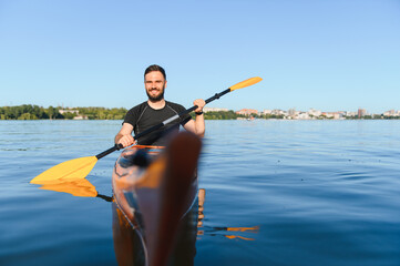 Kayaker paddling on lake enjoying water sports in summer