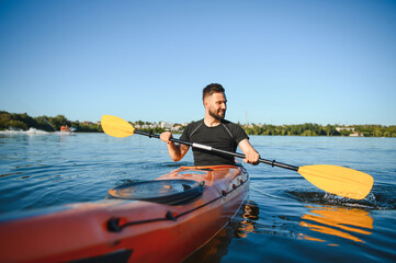 Kayaker paddling on lake enjoying water sports during summer vacation