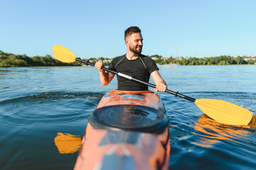 Kayaker paddling kayak on river in sunny day, enjoying water sports and active recreation