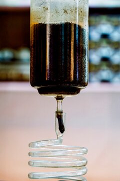 Soxhlet extractor dripping solvent through spiral condenser in chemistry lab
