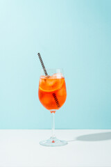 Aperol Spritz, traditional summer cocktail at blue background.