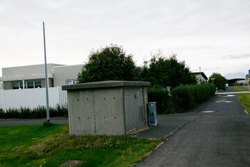 Residential street view with utility structure and greenery in Akranes, Iceland