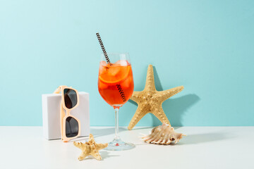 Summer alcohol cocktail drink at blue background. Aperol Spritz in wine glass,