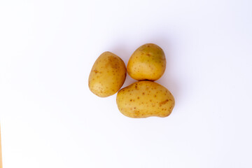 Group of fresh potatoes isolated on white background. Natural vegetable ideal for cooking concepts, recipe designs, and healthy food presentations.