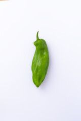 Fresh green chili pepper isolated on white background with copy space. Spicy vegetable perfect for culinary designs, recipes, and food presentations.