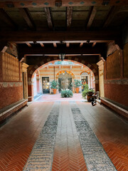Exploring an architectural passage with charming arches and brick paving in a historic building