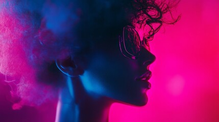 Fototapeta premium Creative portrait of woman with neon blue and pink lighting in dramatic silhouette for fashion visuals