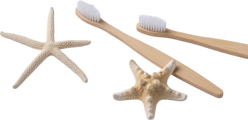 A set of eco-friendly bamboo wooden toothbrushes with starfish on a white towel.