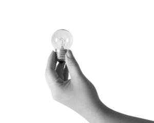 Black and white hand holds a lightbulb. Idea concept. Transparent background