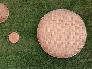 Nyiru is a traditional tool that has a round shape and is made of woven bamboo. The main function of this nyiru is to sip or clean rice.