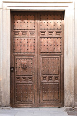 Old wooden carved door with wrought iron details