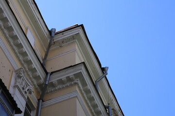 Historic building architecture under clear blue sky in urban environment with intricate molding and...