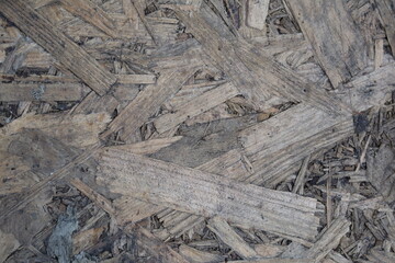 Natural texture of wood chips used for ground cover in a landscaping project during midday sunlight