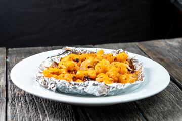 Crispy Shredded Chicken. Chinese Cuisine. A dish of meat. Appetizing chicken on a black background