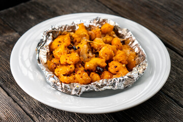 Crispy Shredded Chicken. Chinese Cuisine. A dish of meat. Appetizing chicken on a black background