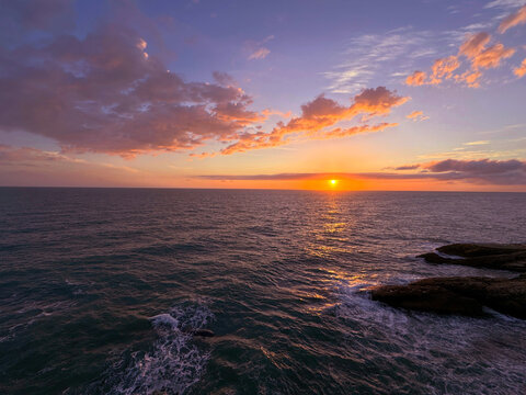 Sunset cloudy sky over storm ocean at evening.