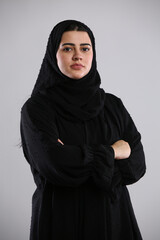 saudi arabian woman in hijaab standing folded hands facing camera in full confidence
