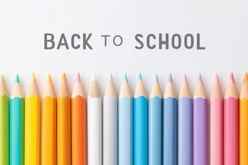 Back to School concept with a row of colorful pencils on a white background. Minimalist top view, flat lay design. A clean, creative banner for education, art, and school supplies.
