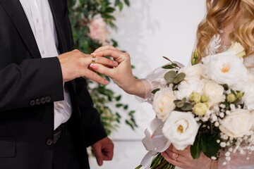 Romantic Wedding Ceremony Exchange of Rings: A Groom Placing a Band on His Bride's Finger, Bouquet,...