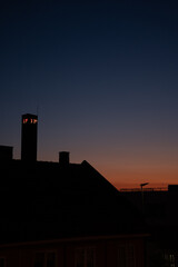 Rooftops and thermometer at night showing tropical heat
